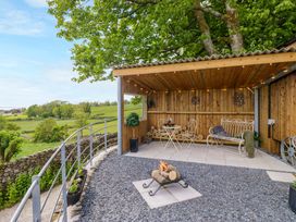 An outdoor seating area with a table and fire pit at Little Hut in Grange-Over-Sands