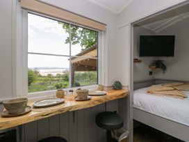 A bedroom with a view and dining area at Little Hut Grange-Over-Sands