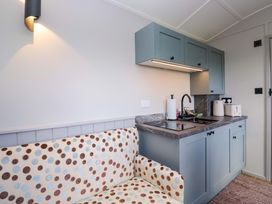 A kitchen with a sink and stove at Little Hut in Grange-Over-Sands