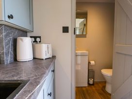 A kitchen area with kettle and toaster at Little Hut in Grange-Over-Sands