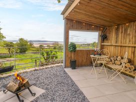 An outdoor area with a fire pit and seating at Little Hut in Grange-Over-Sands