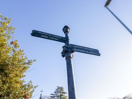 A signpost indicating directions to Town Centre and Leisure Facilities at Little Hut in Grange-Over-Sands