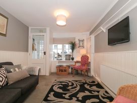 A living room with a sofa and television at Stones Bakery in Wedmore