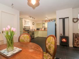 A kitchen featuring a table and chairs with a stove at Stones Bakery in Wedmore