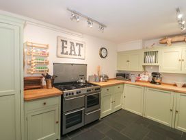 A kitchen with cabinets and an oven at Stones Bakery in Wedmore