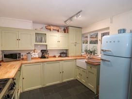 A kitchen with cabinets and appliances at Stones Bakery in Wedmore