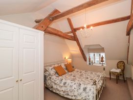 A bedroom with a bed and wardrobe at Stones Bakery in Wedmore