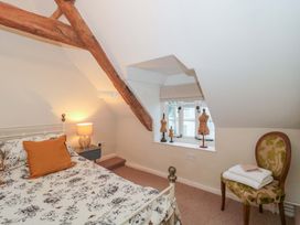A bedroom with a bed and mannequins at Stones Bakery in Wedmore
