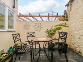 An outdoor seating area with a table and chairs at Stones Bakery in Wedmore