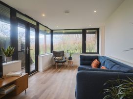 A snug with seating and windows at Little Poppes Lawn in Holditch near Hawkchurch