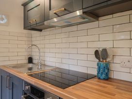 A kitchen with a sink and cooktop at Little Poppes Lawn in Holditch near Hawkchurch