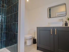 A bathroom with a shower, toilet, and sink at Little Poppes Lawn in Holditch near Hawkchurch