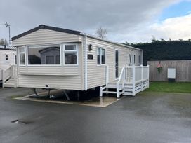 A static caravan with decking and steps at 169 Abergele
