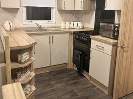 A kitchen with cooking appliances and storage at 169 Abergele