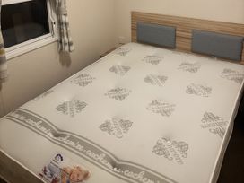 A bedroom with a bed and curtains at 169 Abergele