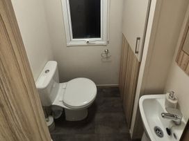 A bathroom with a toilet and sink at 169 Abergele