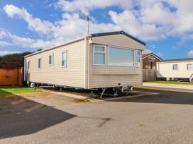 A caravan parked on pavement at St Michaels Caravan Park - 236 Towyn