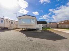 A caravan with steps and a road at St Michaels Caravan Park - 236 Towyn
