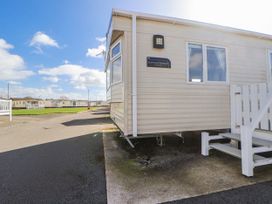 An exterior view of a caravan named Summer Breeze Deluxe at St Michaels Caravan Park - 236 Towyn