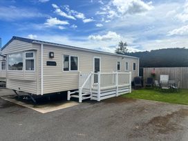 A caravan with seating outside at The Beachside Hideout - St Michaels and Browns Caravan Park in Towyn