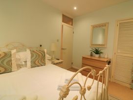 A bedroom with a bed and dresser at Smugglers Cove in Dartmouth