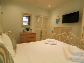 A bedroom with a bed and dresser at Smugglers Cove in Dartmouth