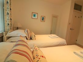 A bedroom with two beds and a mirror at Smugglers Cove in Dartmouth