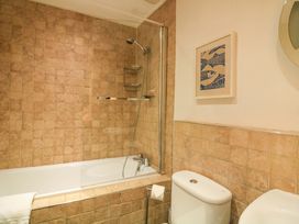 A bathroom with a bathtub, shower, and toilet at Smugglers Cove in Dartmouth