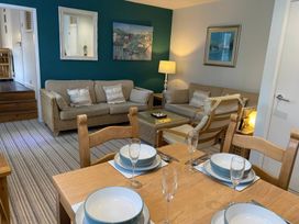 A living room with seating and a dining area at Snugglers Cove in Dartmouth