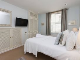 A bedroom with a bed and television at Snugglers Cove in Dartmouth