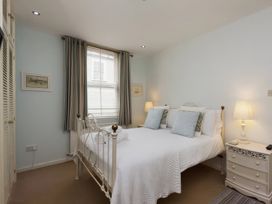 A bedroom with a bed and bedside tables at Snugglers Cove in Dartmouth