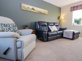 A living room with a recliner chair and a sofa at 27 Oversands View