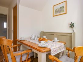 A dining room with a table set for tea at 27 Oversands View