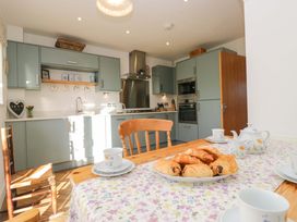 A kitchen with a table set for tea and croissants at 27 Oversands View