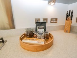 A kitchen counter with jars and a bamboo tray at 27 Oversands View