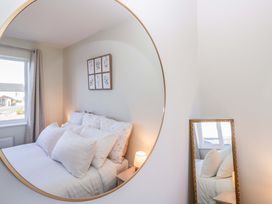 A bedroom with a bed and pillows at 27 Oversands View