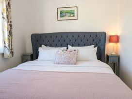 A bedroom with a bed and bedside tables at 27 Oversands View