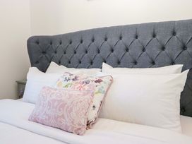 A bed with decorative pillows at 27 Oversands View 