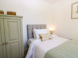 A bedroom with a bed and cabinet at 27 Oversands View