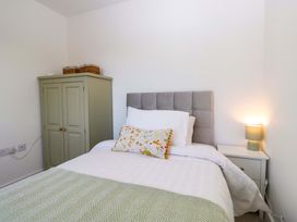 A bedroom with a bed and a wardrobe at 27 Oversands View