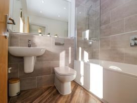 A bathroom with a bath tub and sink at 27 Oversands View