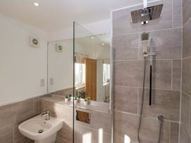 A bathroom with a shower, sink and towel heater at 27 Oversands View