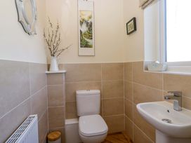 A bathroom with a toilet and sink at 27 Oversands View