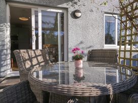 An outdoor seating area with a table and chairs at 27 Oversands View