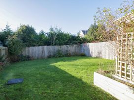 A garden with grass and trees at 27 Oversands View