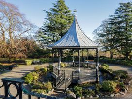 A gazebo surrounded by benches and trees in a park at 27 Oversands View