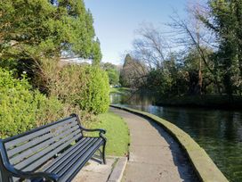 A pathway beside a water body with a bench at 27 Oversands View 
