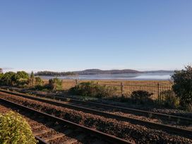 A view of water and land near train tracks at 27 Oversands View 