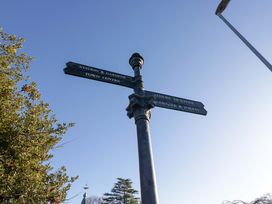 A signpost indicating directions to various locations at 27 Oversands View 