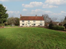 A house with a garden and trees at Farmhouse in Beccles